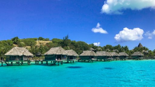 a beach with a bunch of huts in the water