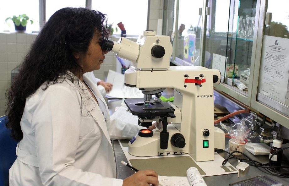 Student voert een scheikundeexperiment uit in een universitair laboratorium