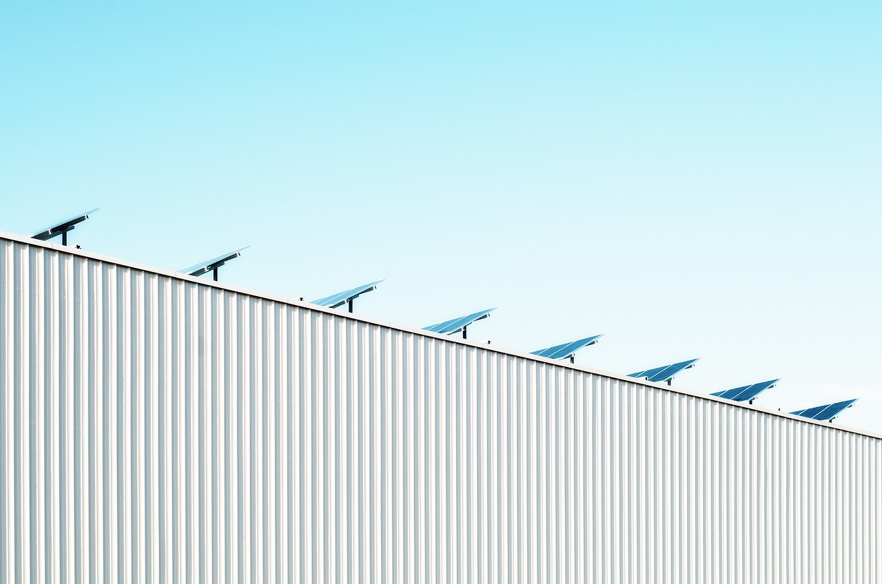 Zonnepanelen op een gerenoveerd dak met dakisolatie zichtbaar langs de dakrand